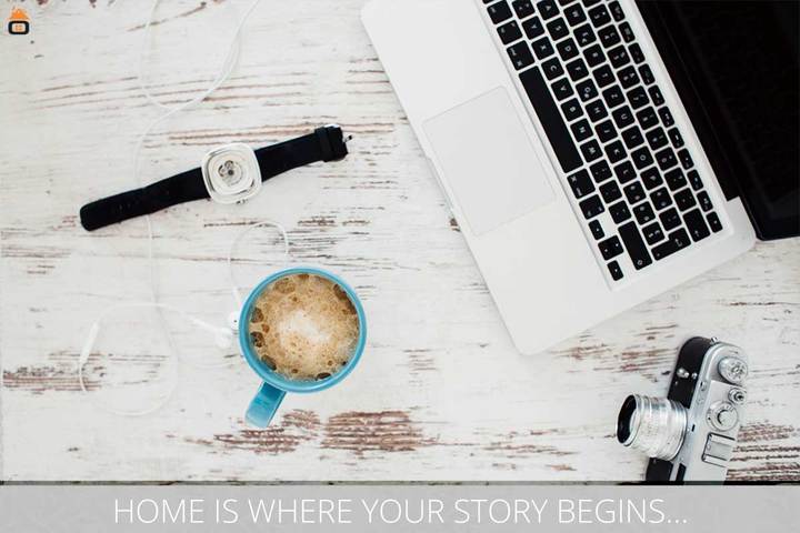 Laptop, coffee and camera on a desk, a typical remote-work setup for a digital nomad in Thailand